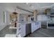 Stylish open kitchen with bar seating, stainless steel appliances, wine storage, and adjacent dining area at 10 Papaya St # 1404, Clearwater Beach, FL 33767