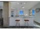 Modern kitchen featuring a breakfast bar, stylish stools, ample counter space, and bright natural lighting at 10 Papaya St # 1404, Clearwater Beach, FL 33767