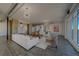 Spacious living room featuring modern industrial design with high ceilings and white furniture at 10 Papaya St # 1404, Clearwater Beach, FL 33767