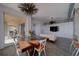 The open living area features a dining space, a living room with modern elements, and a sliding glass door to the outside at 10 Papaya St # 1404, Clearwater Beach, FL 33767