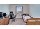 Bedroom featuring a wood bed frame, desk and rolling chair at 12239 Fawn Brindle St, Riverview, FL 33578