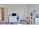 Bright bedroom with carpet flooring, television, and built in shelving units at 12239 Fawn Brindle St, Riverview, FL 33578