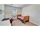 Well-lit bedroom featuring carpet floors, a window view, and ample desk space at 12239 Fawn Brindle St, Riverview, FL 33578