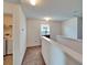 Upstairs hallway with laundry area, carpet and white railing at 12239 Fawn Brindle St, Riverview, FL 33578