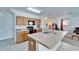 Kitchen island features a dual sink and ample counterspace with wooden cabinets at 12239 Fawn Brindle St, Riverview, FL 33578