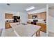 Kitchen island features a dual sink and ample counterspace with wooden cabinets at 12239 Fawn Brindle St, Riverview, FL 33578