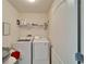 Convenient laundry room with washer, dryer, and built-in shelving for storage at 12239 Fawn Brindle St, Riverview, FL 33578