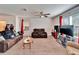 Cozy carpeted living room with ceiling fan, brown leather sofas and bright natural light at 12239 Fawn Brindle St, Riverview, FL 33578