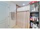 Shower area with a patterned shower curtain and shelves at 12239 Fawn Brindle St, Riverview, FL 33578