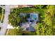 Aerial view showcasing a home with solar panels and a private pool with a screened enclosure at 16311 Colwood Dr, Odessa, FL 33556