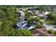 Aerial view of the neighborhood with houses surrounded by lush green trees at 16311 Colwood Dr, Odessa, FL 33556