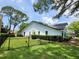 Well maintained backyard with black metal fence and partial view of the home's exterior at 16311 Colwood Dr, Odessa, FL 33556