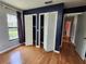 Bedroom featuring ample closet space with bi-fold doors and hardwood flooring for practical storage solutions at 16311 Colwood Dr, Odessa, FL 33556