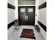 Close-up of the double front doors, featuring stylish hardware and decorative welcome mat at 16311 Colwood Dr, Odessa, FL 33556