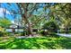 Charming home with lush green lawn, mature trees, and manicured landscaping offering great curb appeal at 16311 Colwood Dr, Odessa, FL 33556