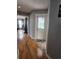 Hallway with hardwood floors leading to the bedroom and an exterior door to the pool area at 16311 Colwood Dr, Odessa, FL 33556