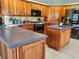 Spacious kitchen featuring a center island, wood cabinets, and modern appliances at 16311 Colwood Dr, Odessa, FL 33556