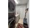 Functional laundry area with stackable washer/dryer, counter space and storage at 16311 Colwood Dr, Odessa, FL 33556