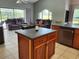 Spacious living area featuring an island, seamlessly connecting the kitchen and Gathering room at 16311 Colwood Dr, Odessa, FL 33556