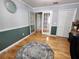 This open living room features French doors, a two-tone paint scheme, and hardwood floors at 16311 Colwood Dr, Odessa, FL 33556