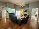 Warm and inviting living room featuring hardwood floors, a fireplace, and comfortable seating at 16311 Colwood Dr, Odessa, FL 33556