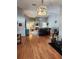 Bright living room with hardwood floors, fireplace, ceiling fan, and modern lighting fixture at 16311 Colwood Dr, Odessa, FL 33556