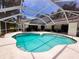 Relaxing pool area with ample seating and a screened-in enclosure, perfect for enjoying the outdoors bug-free at 16311 Colwood Dr, Odessa, FL 33556