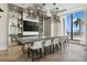 Modern club room with a long table, stylish light fixtures, and ocean view at 301 1St S St # 1605, St Petersburg, FL 33701