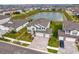 An aerial view of a two-story home with pond views in a residential neighborhood at 32346 Sapna Chime Dr, Wesley Chapel, FL 33545
