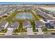 Aerial view of community, showcasing a beautiful lake at 32346 Sapna Chime Dr, Wesley Chapel, FL 33545