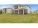 Manicured backyard with a covered patio for outdoor living at 32346 Sapna Chime Dr, Wesley Chapel, FL 33545