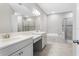 Large bathroom featuring a soaking tub, walk-in shower, and double vanity sinks at 32346 Sapna Chime Dr, Wesley Chapel, FL 33545