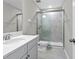 Clean bathroom with glass-enclosed shower, modern finishes, and white cabinets at 32346 Sapna Chime Dr, Wesley Chapel, FL 33545