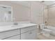 Bright bathroom with tub and shower combo and sink with white cabinets at 32346 Sapna Chime Dr, Wesley Chapel, FL 33545