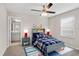 Stylishly decorated bedroom with ceiling fan and ensuite bathroom access at 32346 Sapna Chime Dr, Wesley Chapel, FL 33545
