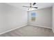 Simple bedroom with neutral walls, a ceiling fan, and a window at 32346 Sapna Chime Dr, Wesley Chapel, FL 33545