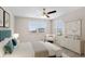 Bright bedroom featuring neutral walls, ceiling fan, and cozy decor at 32346 Sapna Chime Dr, Wesley Chapel, FL 33545