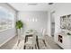 Dining room with a glass table, seating for six, and modern hanging lights at 32346 Sapna Chime Dr, Wesley Chapel, FL 33545
