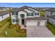 Gorgeous two-story home with a three-car garage and professionally landscaped yard at 32346 Sapna Chime Dr, Wesley Chapel, FL 33545