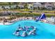 The Epperson Lagoon aqua park, featuring inflatable obstacle course, water slide, and beach at 32346 Sapna Chime Dr, Wesley Chapel, FL 33545