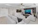 Spacious living room/media room with comfortable seating, large screen TV, ceiling fan, and recessed lighting at 32346 Sapna Chime Dr, Wesley Chapel, FL 33545