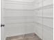 Walk-in pantry offers ample storage with white wire shelves, providing practical and easy organization for kitchen essentials at 32346 Sapna Chime Dr, Wesley Chapel, FL 33545