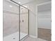 Modern shower with glass door and tiled walls in a pristine bathroom at 32346 Sapna Chime Dr, Wesley Chapel, FL 33545