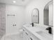 Modern bathroom featuring double sinks, quartz countertops, matte black fixtures, and a tiled shower at 3401 E Hanna Ave, Tampa, FL 33610