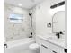 Stylish bathroom with white marble tile, a tub, and modern black fixtures at 3401 E Hanna Ave, Tampa, FL 33610