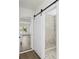 Modern bathroom with marble-tiled walk-in shower and sliding door at 3401 E Hanna Ave, Tampa, FL 33610