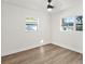 Inviting bedroom with wood floors, ceiling fan, and dual windows at 3401 E Hanna Ave, Tampa, FL 33610