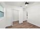 Bright bedroom features wood-look floors, neutral paint, ceiling fan and closet with bi-fold doors at 3401 E Hanna Ave, Tampa, FL 33610
