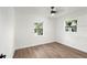 Bedroom with wood floors, ceiling fan and two windows at 3401 E Hanna Ave, Tampa, FL 33610