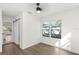 Bright bedroom with wood floors, ceiling fan, and natural light from the large window at 3401 E Hanna Ave, Tampa, FL 33610